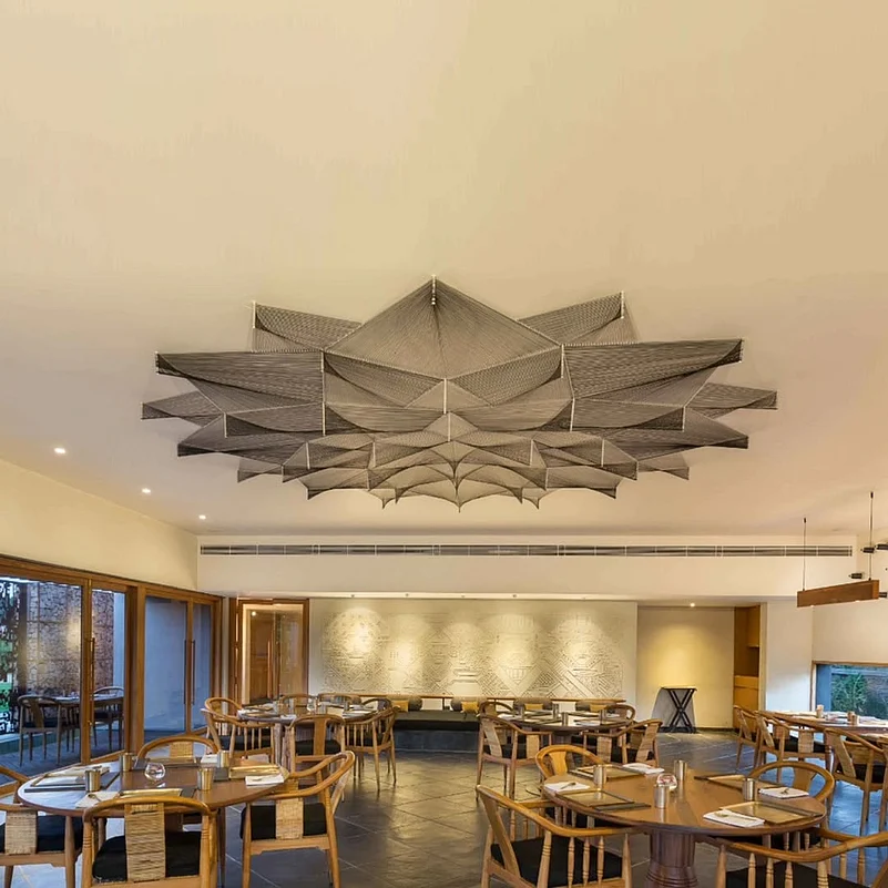 The nail and thread artwork on the ceiling of Swadesh restaurant