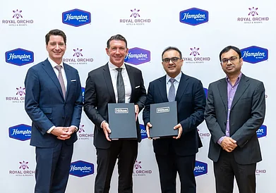 Photo by Hilton : Image (L-R): Christian Charnaux, Executive Vice President and Chief Development Officer, Hilton; Alan Watts, President, Asia Pacific Hilton; Arjun Baljee, President, Royal Orchid Hotels and Keshav Baljee, Executive Director, Royal Orchid Hotels