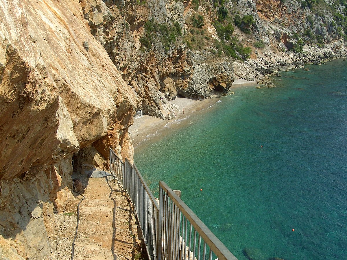Pasjača Beach is carved into the base of towering limestone cliffs 