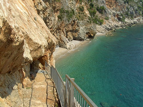 Pasjača Beach is carved into the base of towering limestone cliffs 