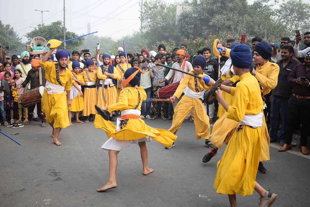 Sikhs perform Gatka during a Nagar Kirtan procession