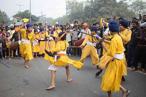 Sikhs perform Gatka during a Nagar Kirtan procession