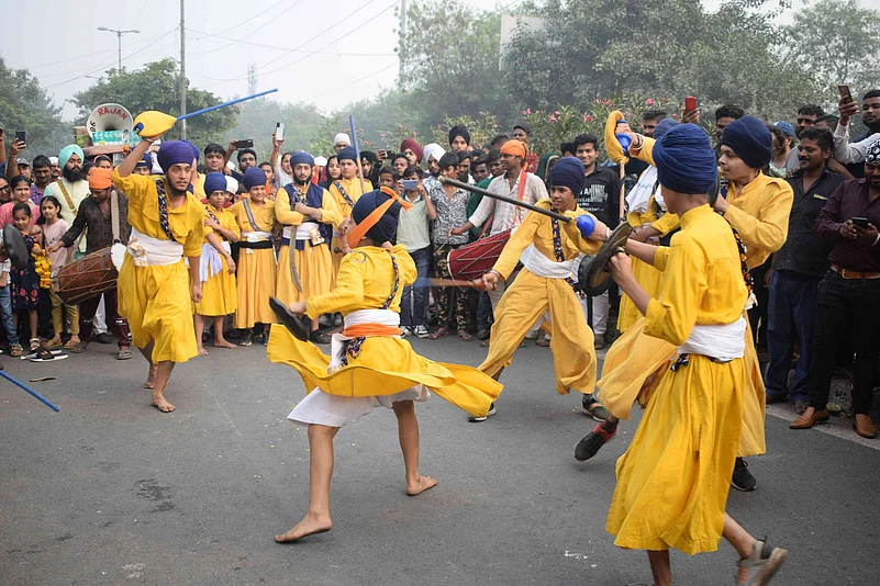 Sikhs perform Gatka during a Nagar Kirtan procession