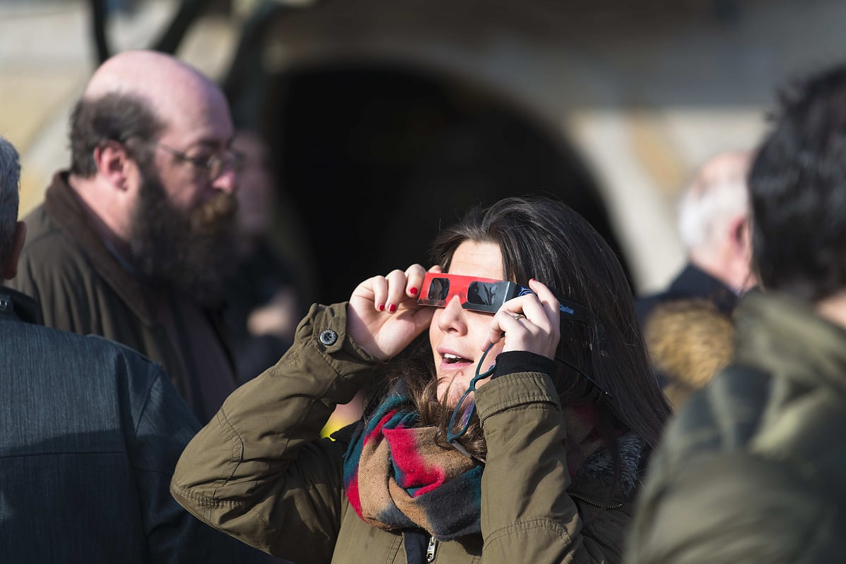 People gather to watch a near-total solar eclipse in Spain