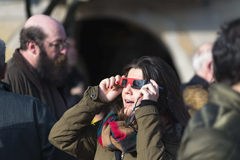 People gather to watch a near-total solar eclipse in Spain
