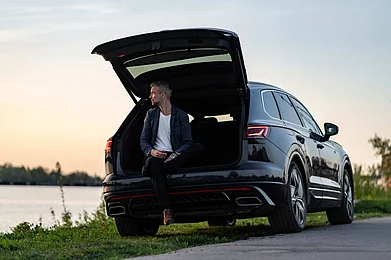 Shutterstock : Volkswagen Touareg parked by a riverside at sunset
