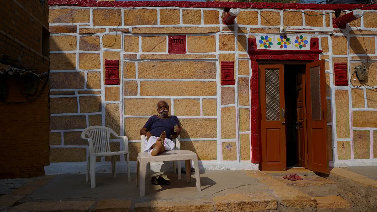 An elderly man poses in front of his ancestral house in Jaisalmer