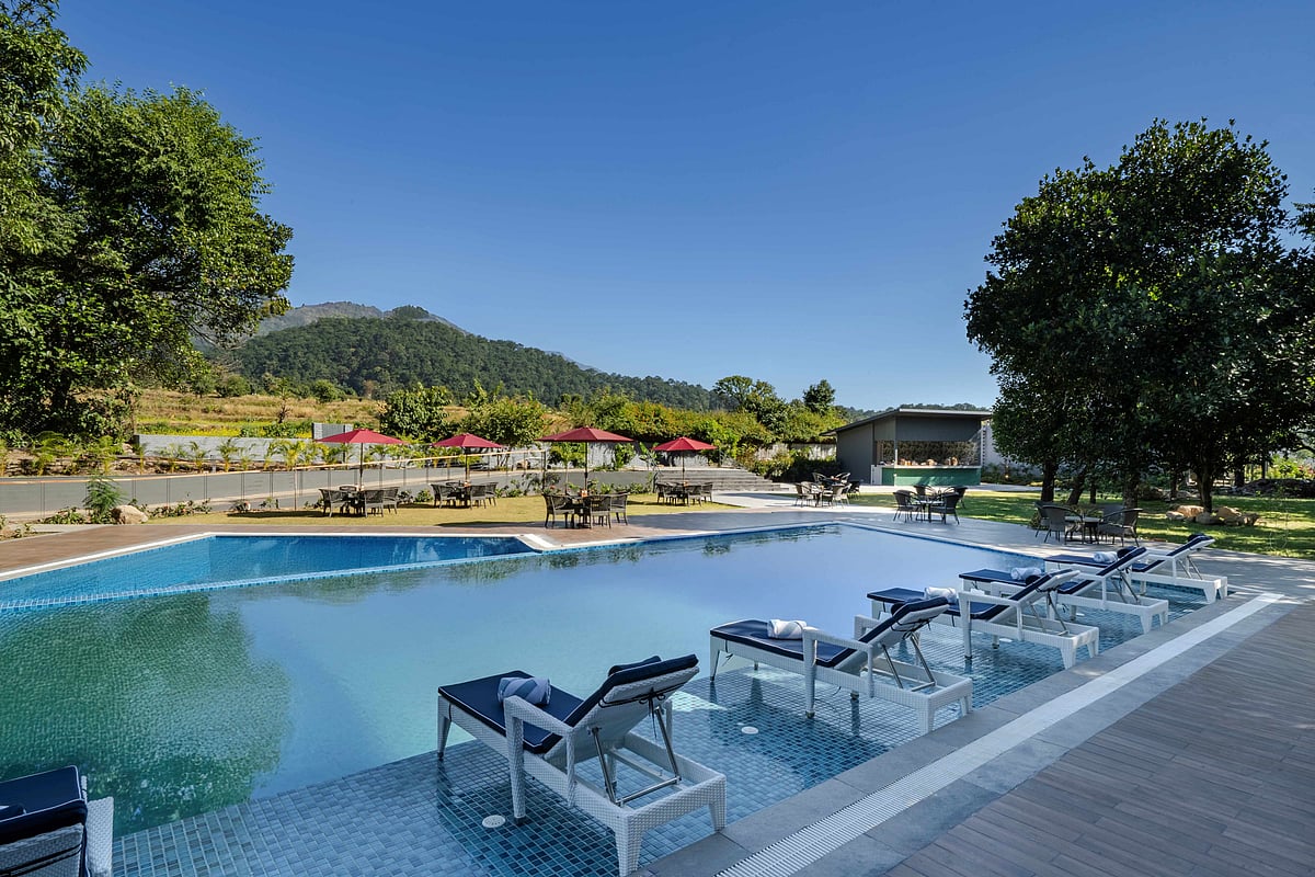 The swimming pool at Vandhara Sarovar Premiere, Patkote, with a view of the mountains