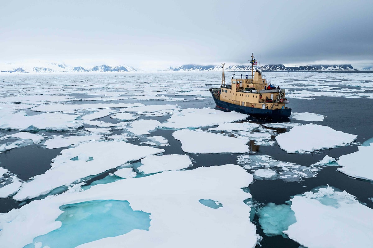 Expedition vessel navigating through sea ice in Svalbard