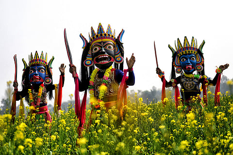 Masked dancers of a Gomira dance troupe perform in Kushmandi village near Raiganj