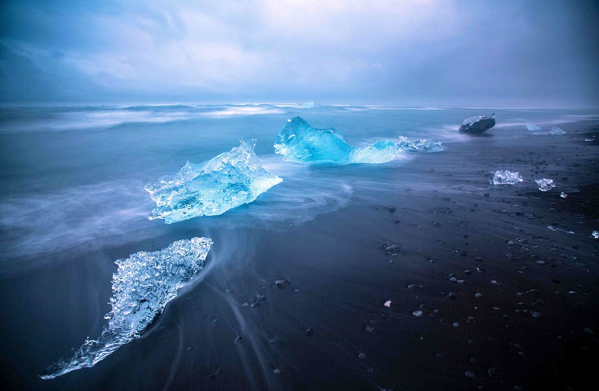 Moonlight reflects off floating icebergs at Jökulsárlón Glacier Lagoon in Iceland