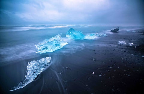 Moonlight reflects off floating icebergs at Jökulsárlón Glacier Lagoon in Iceland