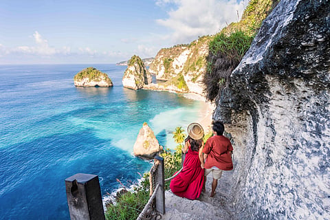 A couple enjoying the dramatic coastline at Diamond Beach in Nusa Penida