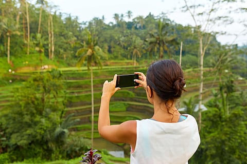 A traveller explores Bali’s iconic terraced rice fields