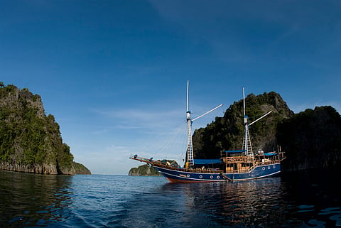 Above the waterline, thousands of islands rise in dramatic limestone karst formations