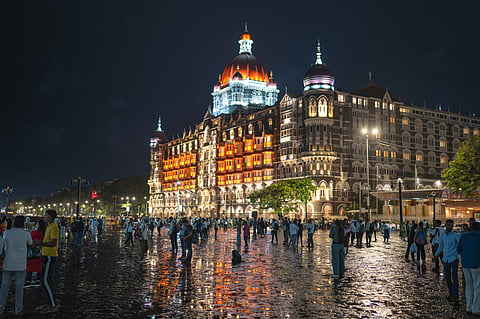 The Taj Mahal Palace, Mumbai illuminated against the Mumbai skyline at night
