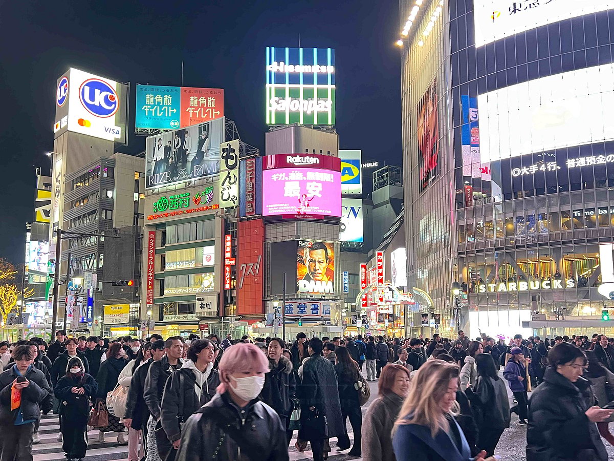Shibuya Crossing glows beneath towering LED billboards in Tokyo