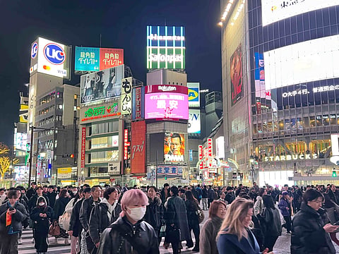 Shibuya Crossing glows beneath towering LED billboards in Tokyo