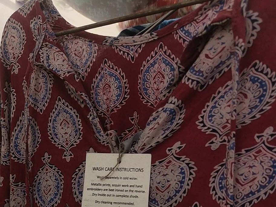 A garment made a Sundarraang showing the tag of the artisan who made it. 