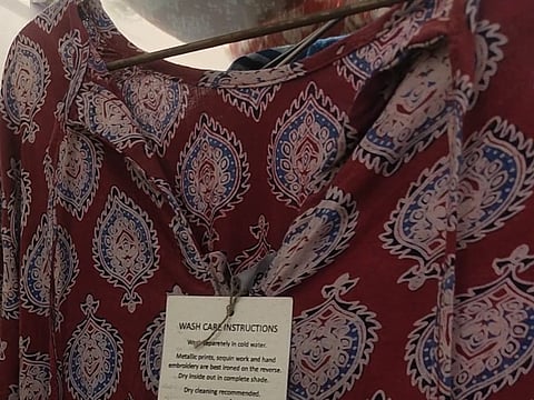 A garment made a Sundarraang showing the tag of the artisan who made it. 
