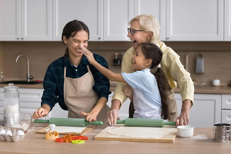 Three generations bond over baking in the kitchen