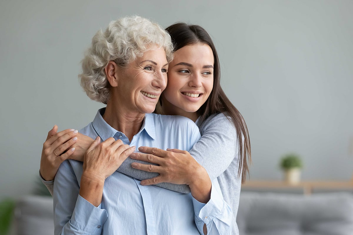 A grandmother and granddaughter share a warm moment together