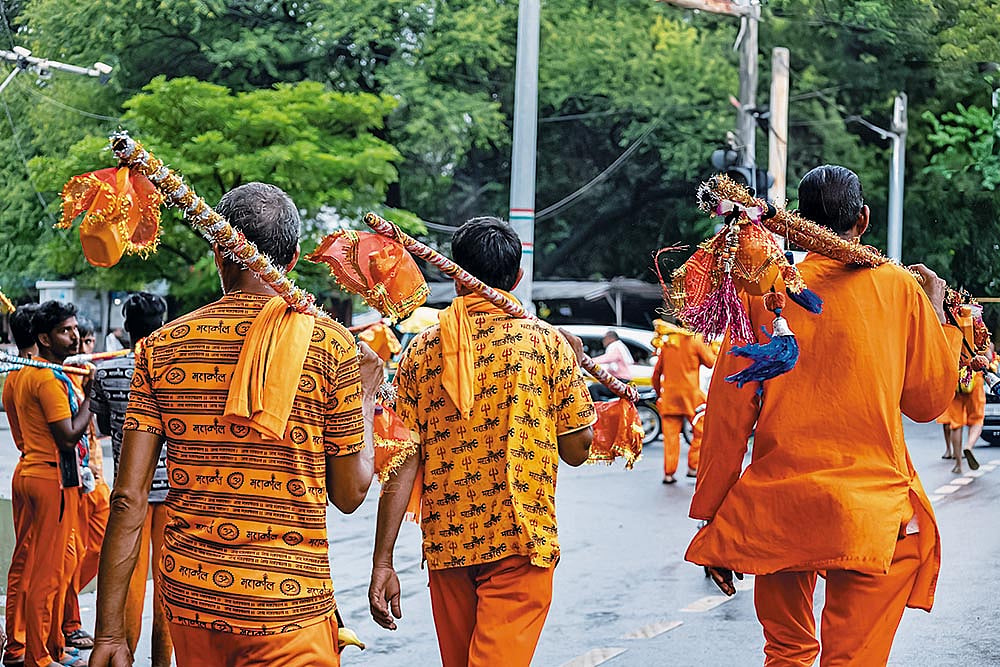 The kanwariyas, clad in saffron, walk for miles carrying holy water