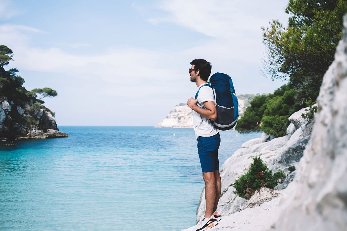 A traveller embraces nature amid scenic mountain views