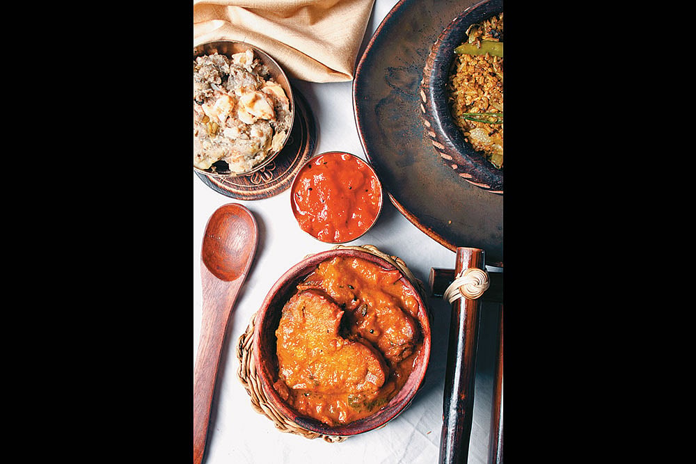 A traditional Assamese spread featuring a variety of local dishes