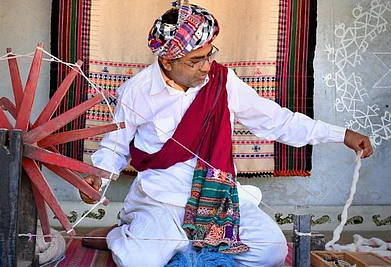 Vankar Chetan : The Vankar family of Bhujodi represents a multi-generational legacy of master weavers in Indias famous craft village of Bhujodi, located just 8 km from Bhuj in Kutch, Gujarat. In frame: Chaman Siju, National Award-winning Bhujodi weaver (2001) and uncle of Vankar Chetan, preparing yarn using a traditional spinning wheel.