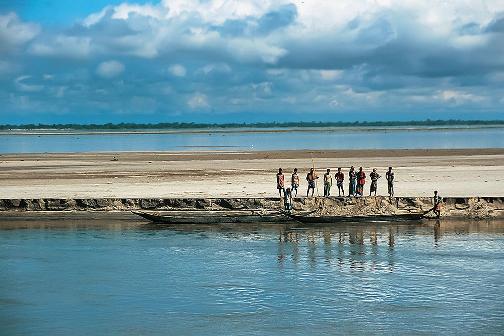 Brahmaputra River/Assam:
Seen from a river cruise, local people move along the Brahmaputra, one of Asia’s great transboundary rivers and a lifeline for transport, trade, farming, fishing and floodplain communities