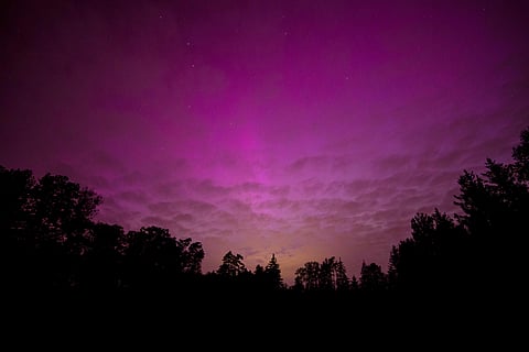 Auroras illuminate the night sky during a geomagnetic storm