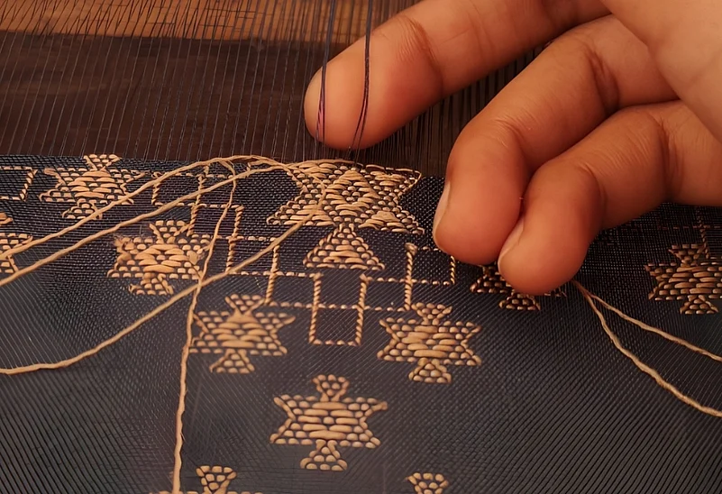 In extra-weft weaving, traditionally worked on pit looms, supplementary threads are inserted into the ground weave to create intricate decorative motifs and patterns.