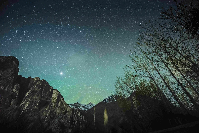 The night sky glows above the mountains of Ladakh