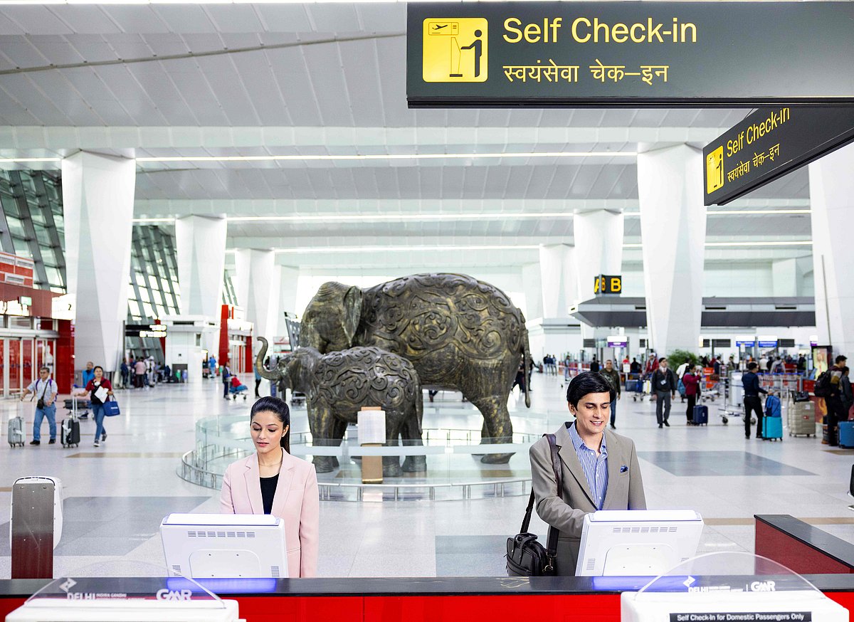 Passengers at self check-in desk at Delhi Airport T3