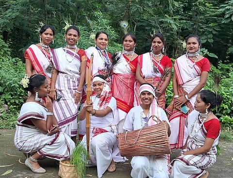 Members of the Oraon community dressed in traditional attire during a community gathering in Jharkhand.