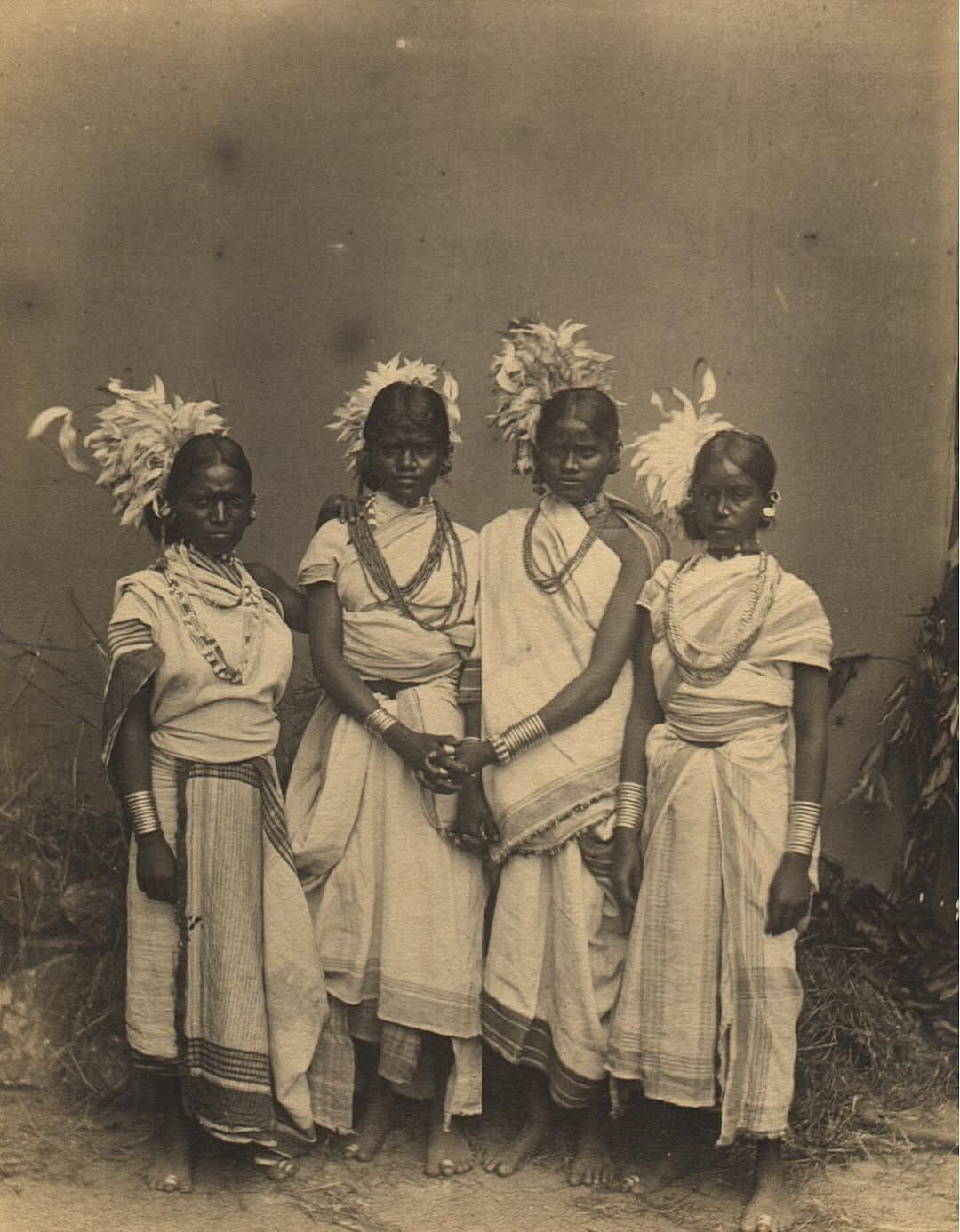 Oraon (Kurukh) women dressed for the Karam festival dance, photographed in India between 1870 and 1899. 