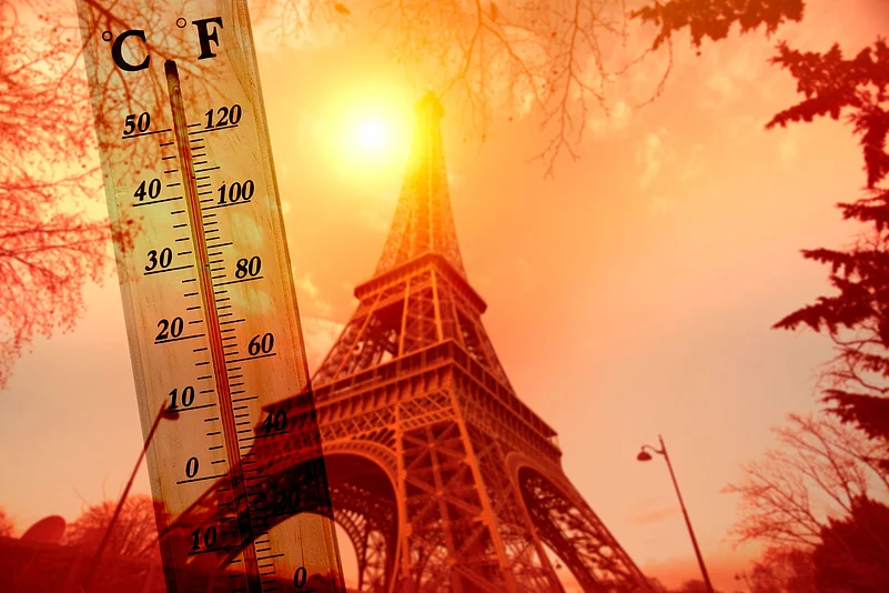 The Eiffel Tower stands beneath the blazing summer sun during Paris heatwave