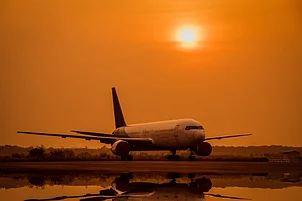 Shutterstock : A airplane lands on an offshore platform at sunset