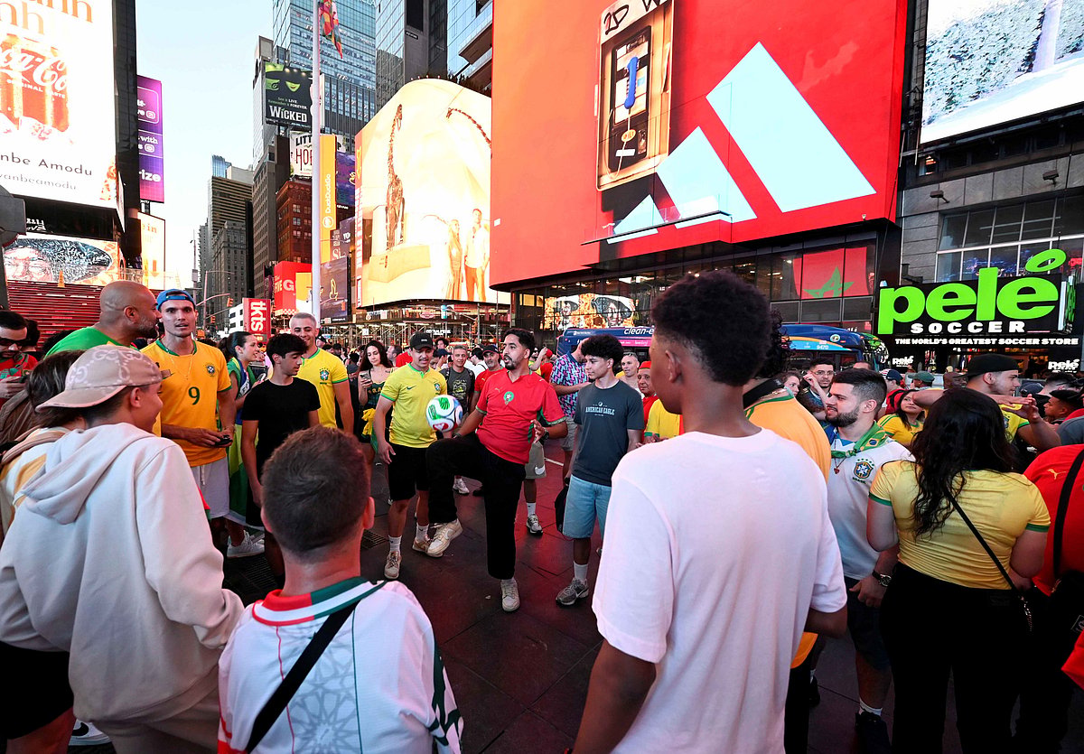 Football fans celebrate in Times Square during the FIFA World Cup