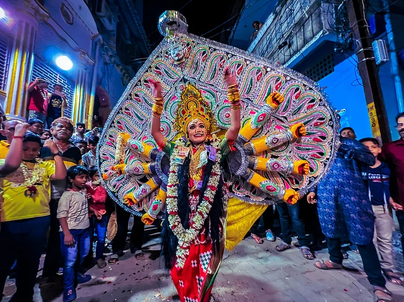 A child performer dressed as Durga Medha - Goddess Durga, dressed on Tatti- Shola Pith