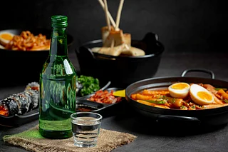 Shutterstock : Soju paired with classic Korean side dishes for an authentic dining experience