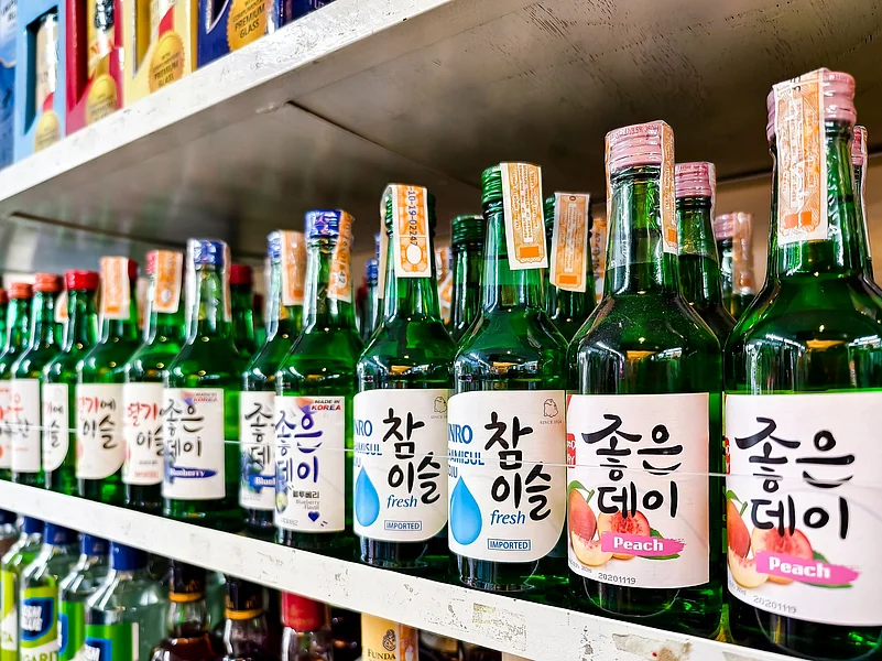 A colourful display of Korean soju bottles on store shelves