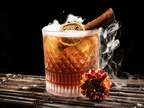 A cocktail with smoke and cinnamon