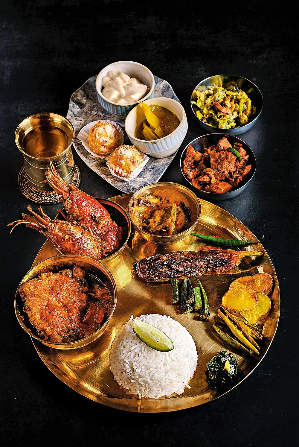 Bengali wedding feast with fish, sweets, and traditional dishes