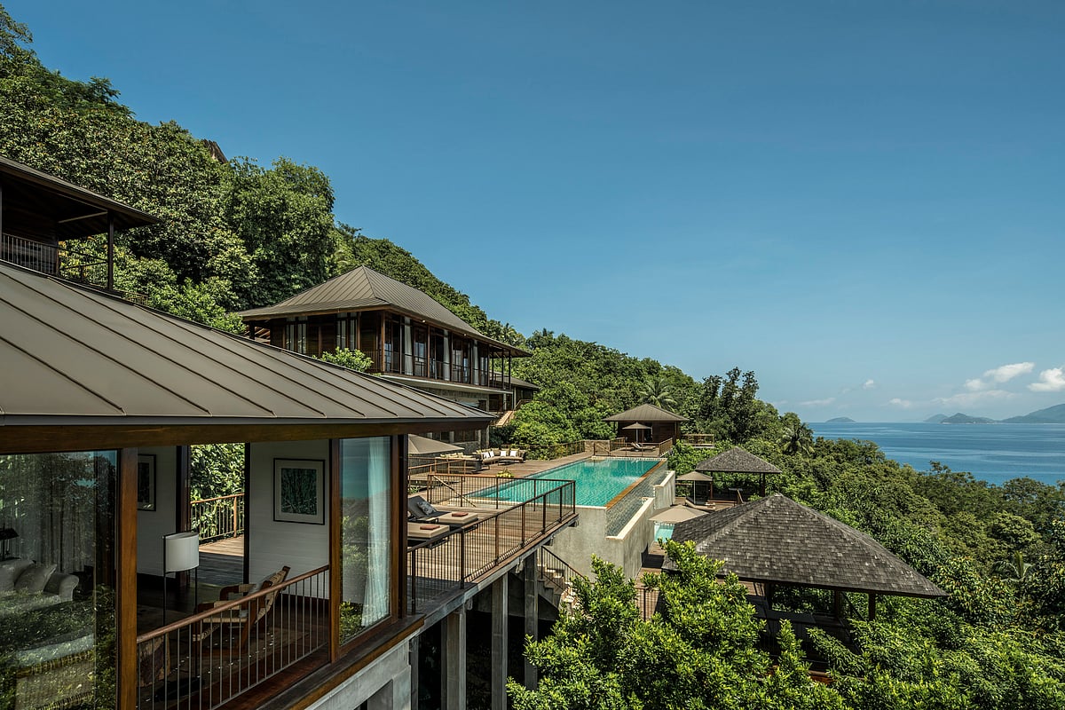 Villas sit at different elevations, partly screened by tropical plants and granite boulders.