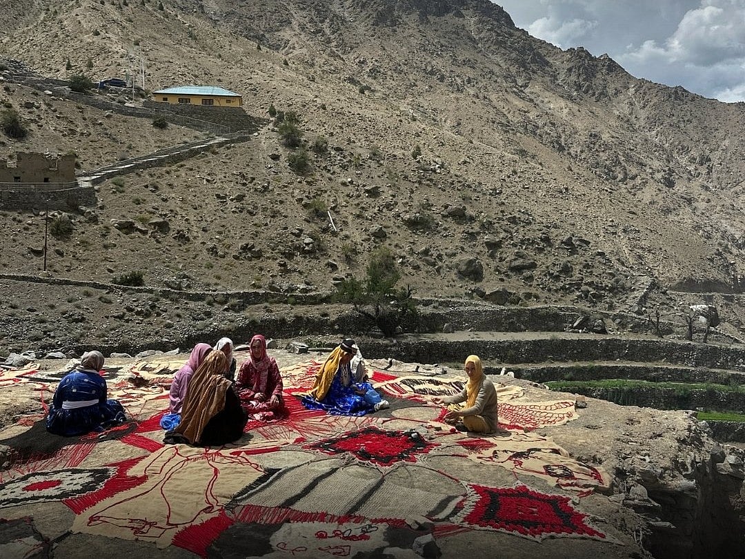 Local women participate in the preparation of another artwork