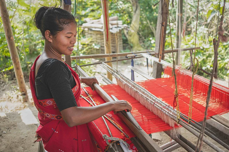 A weaver from Assam on her loom