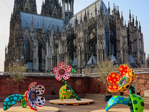 Kusama's large-scale outdoor installations cover sculptures, buildings and public spaces in repeating patterns