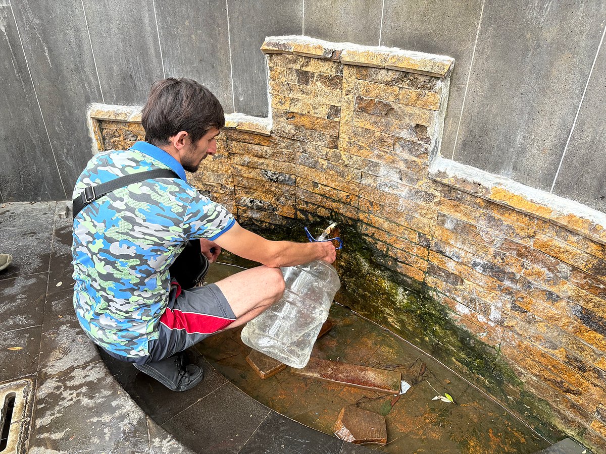 A tourist filling Borjomis mineral water